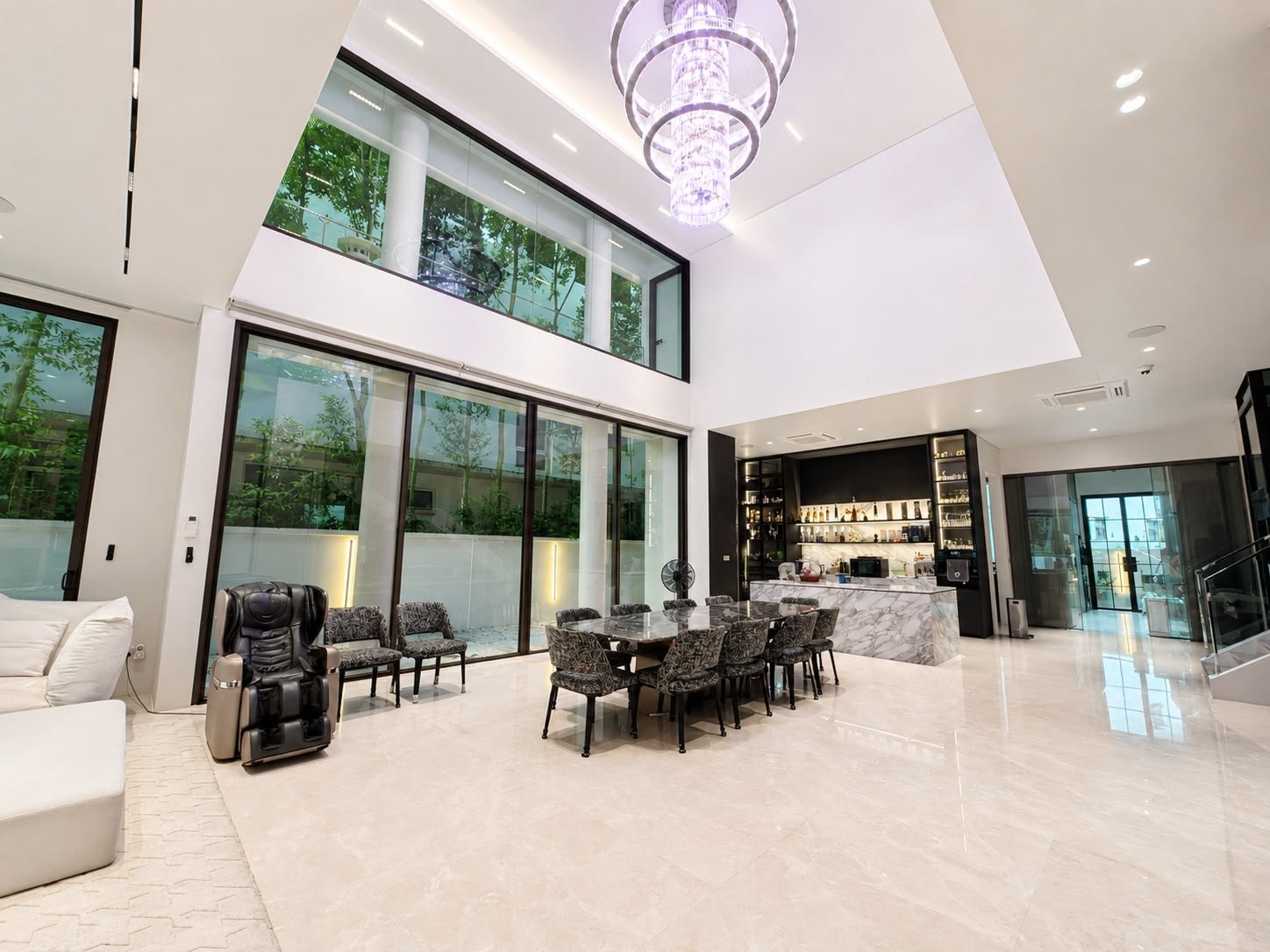 Double-volume living and dining with the bar beyond